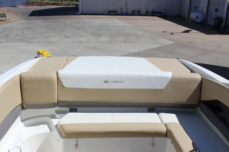 Slide: The Image of 2005 Larson LXi 268 boat interior with beige seating at a marina. - 7