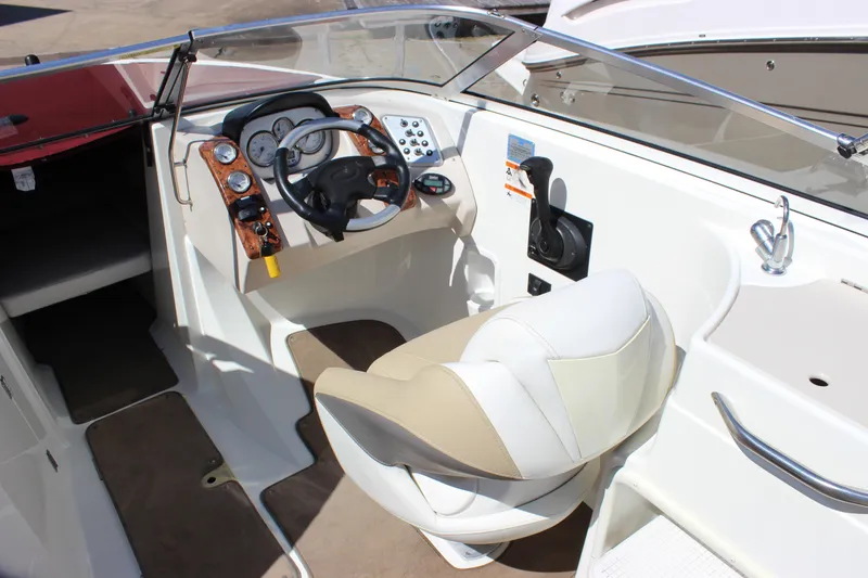 Slide: The Image of 2005 Larson LXi 268 boat cockpit with steering wheel and control panel. - 8