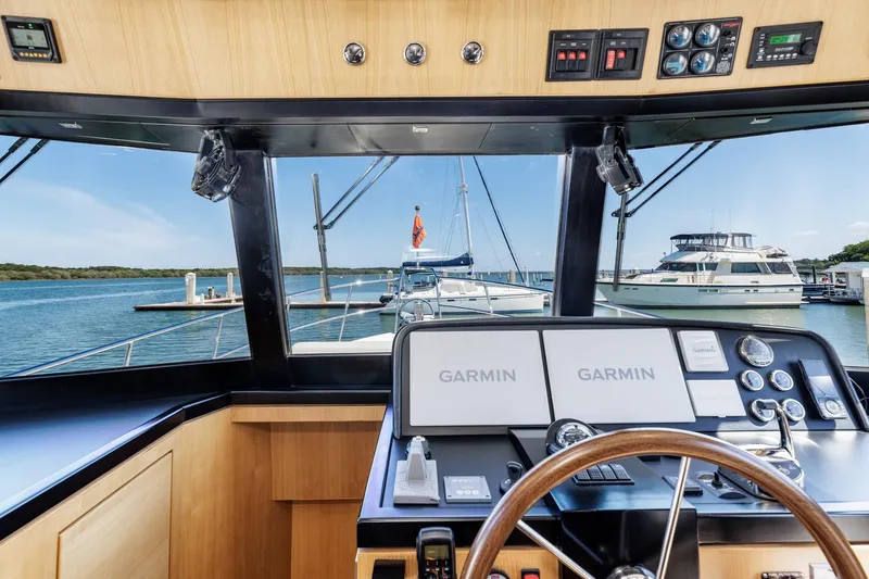 Slide: The Image of Helm of 2023 North Pacific 49 Euro yacht with Garmin navigation, docked at marina. - 12