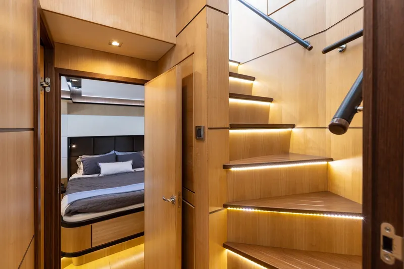 Slide: The Image of Luxurious interior of 2023 North Pacific 49 Euro yacht with modern staircase and cozy bedroom. - 15