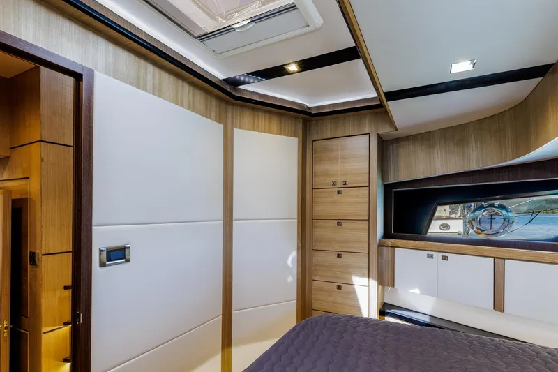 Slide: The Image of Luxurious interior of 2023 North Pacific 49 Euro yacht, featuring modern wood paneling and elegant design. - 21
