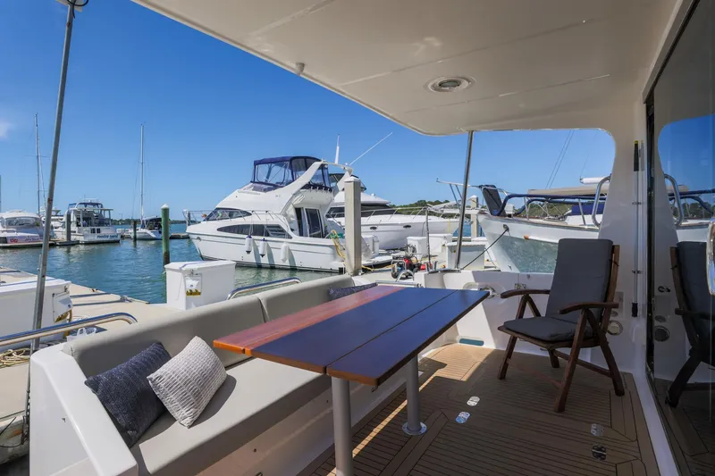 Slide: The Image of 2023 North Pacific 49 Euro yacht deck with seating, docked at marina. - 24