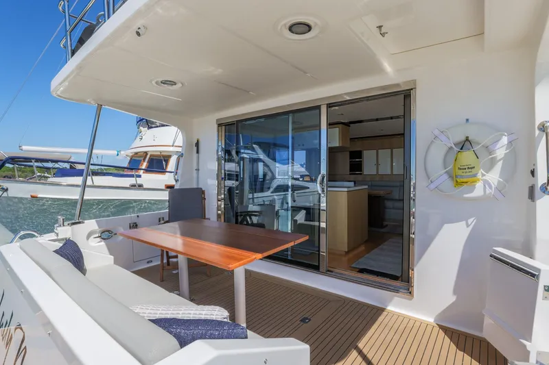 Slide: The Image of Outdoor seating area on 2023 North Pacific 49 Euro yacht with sliding glass doors. - 26