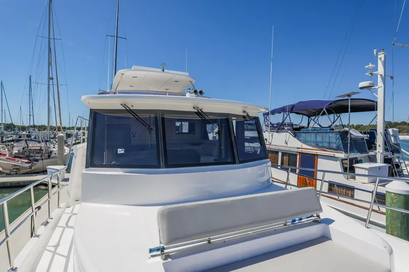 Slide: The Image of 2023 North Pacific 49 Euro yacht docked at a marina under clear blue skies. - 31