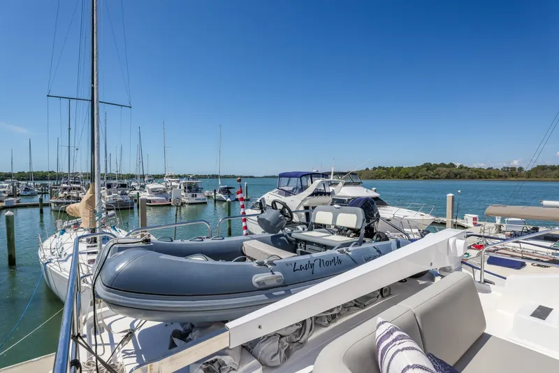 Slide: The Image of 2023 North Pacific 49 Euro yacht docked at marina with inflatable boat on deck. - 38