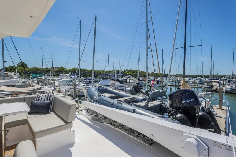 Slide: The Image of 2023 North Pacific 49 Euro yacht at marina, featuring spacious deck and inflatable boat. - 39