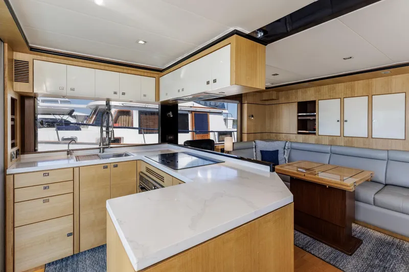Slide: The Image of Modern kitchen and lounge area in 2023 North Pacific 49 Euro yacht, featuring sleek cabinetry and seating. - 4