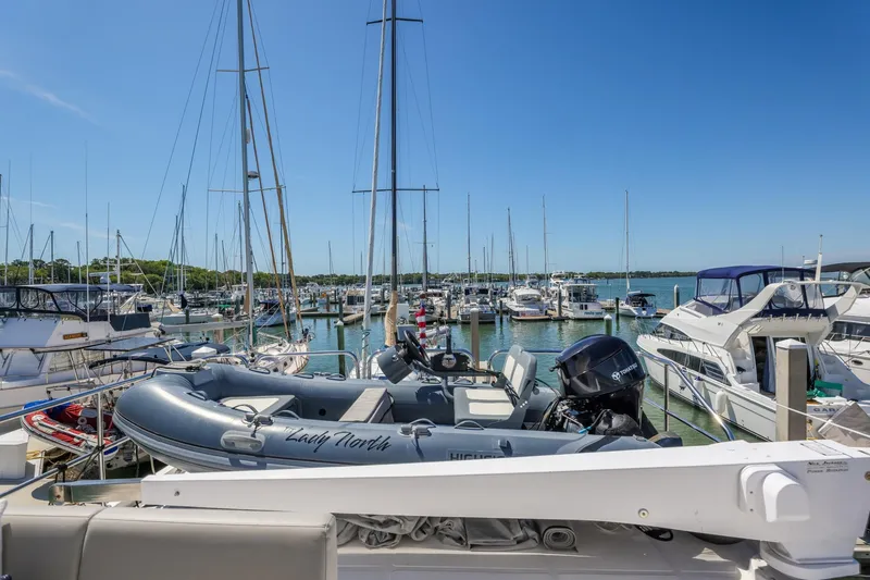 Slide: The Image of Marina view with 2023 North Pacific 49 Euro yacht, surrounded by boats under clear blue sky. - 40