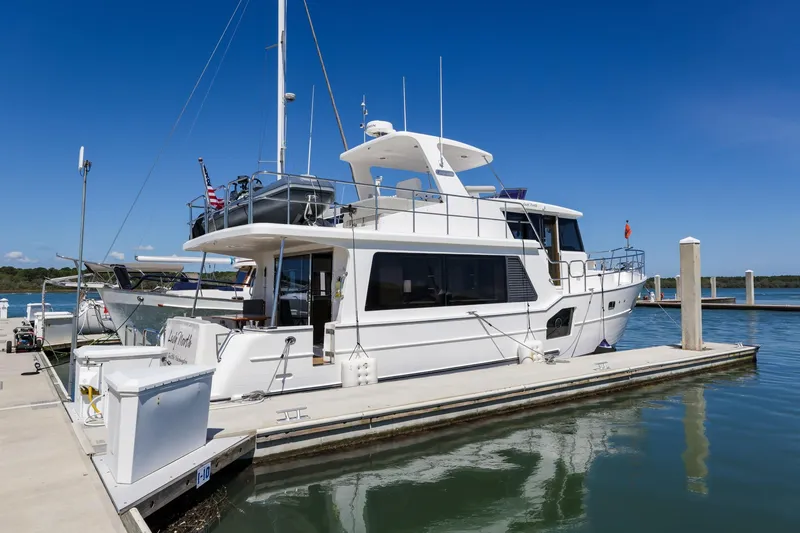 Slide: The Image of 2023 North Pacific 49 Euro yacht docked at marina under clear blue sky. - 41