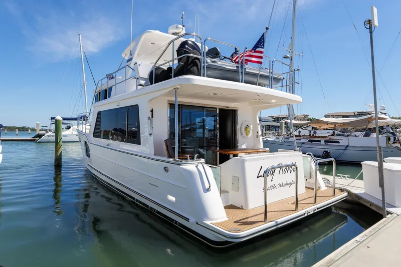 Slide: The Image of 2023 North Pacific 49 Euro yacht docked at marina under clear blue sky. - 42