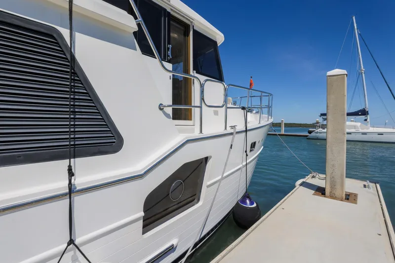 Slide: The Image of 2023 North Pacific 49 Euro yacht docked at marina under clear blue sky. - 44