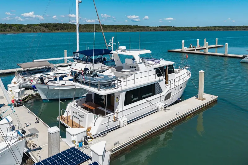 Slide: The Image of 2023 North Pacific 49 Euro yacht docked at a marina under clear blue skies. - 46