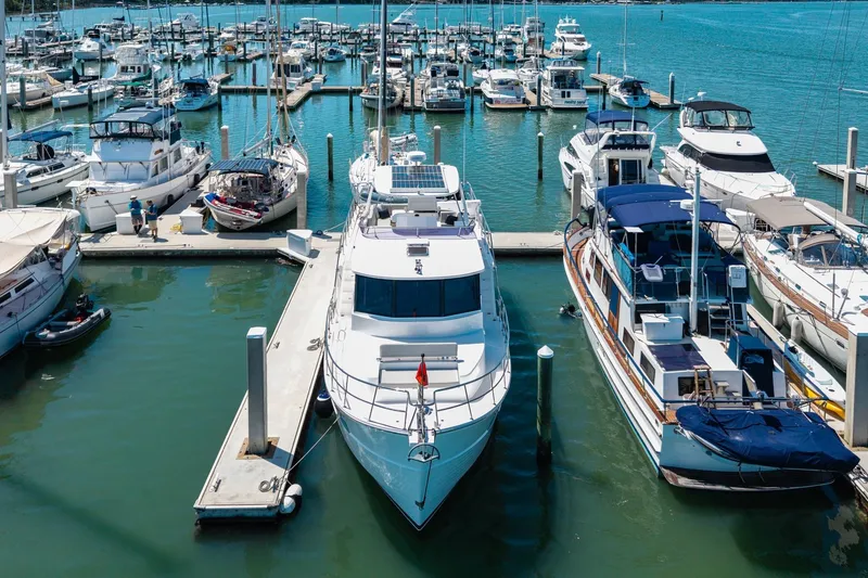 Slide: The Image of 2023 North Pacific 49 Euro yacht docked in a bustling marina with other boats. - 47