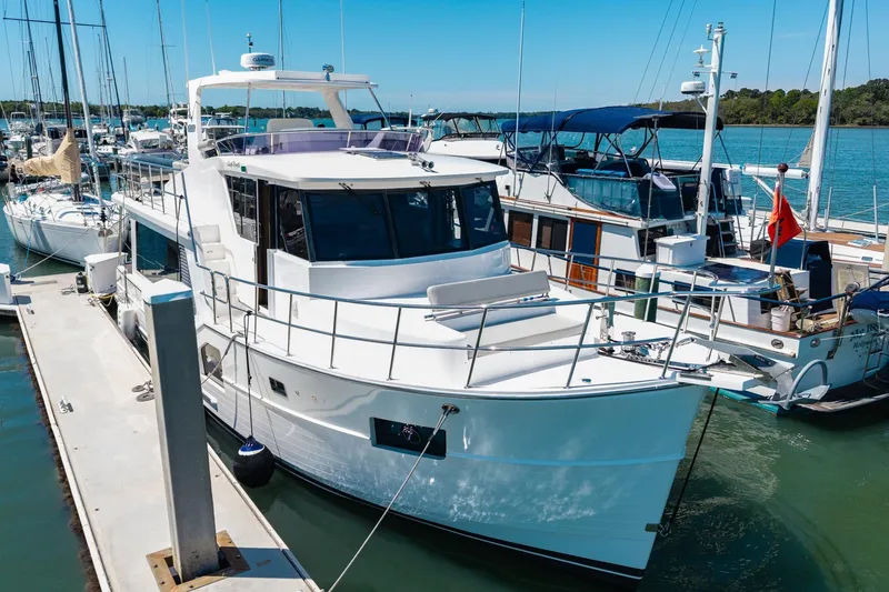 Slide: The Image of 2023 North Pacific 49 Euro yacht docked at marina under clear blue sky. - 50
