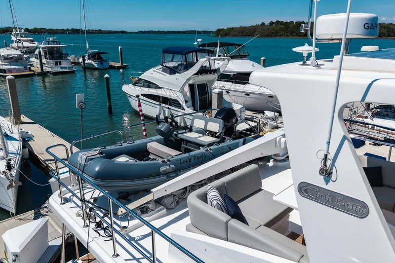 Slide: The Image of 2023 North Pacific 49 Euro yacht docked at marina with inflatable boat. - 51