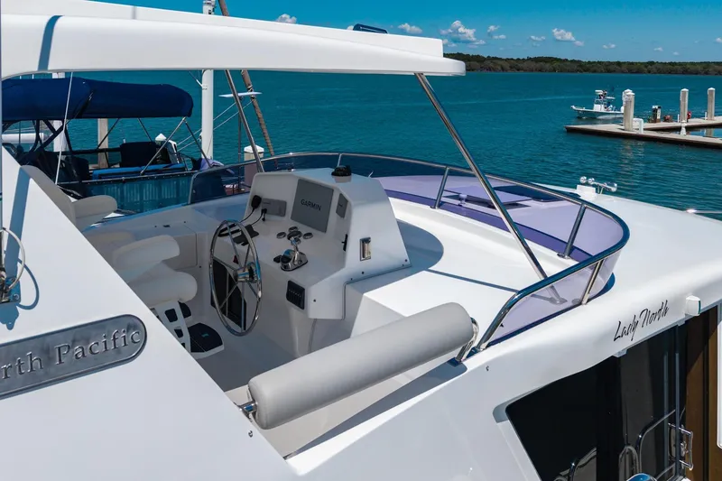 Slide: The Image of Flybridge of 2023 North Pacific 49 Euro yacht with steering wheel and Garmin navigation system. - 52