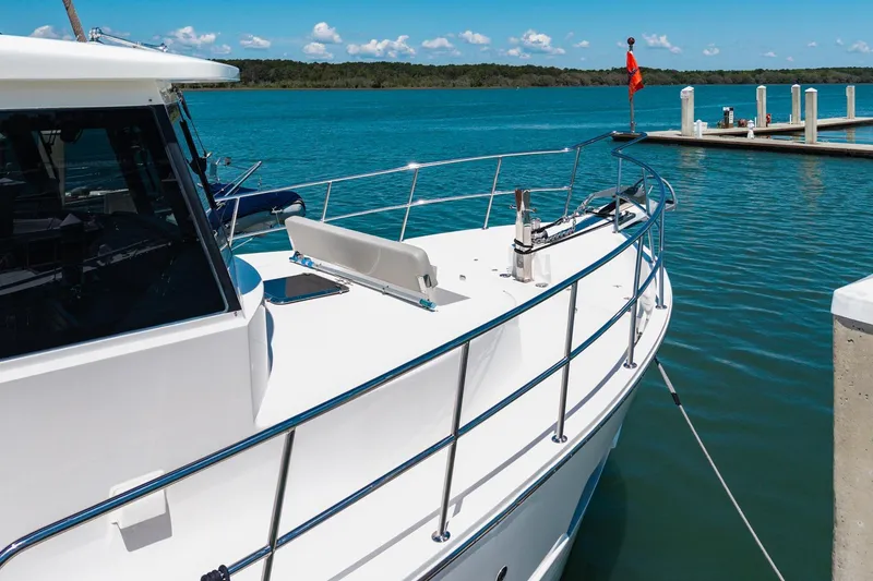 Slide: The Image of 2023 North Pacific 49 Euro yacht docked at a marina with clear blue water. - 53