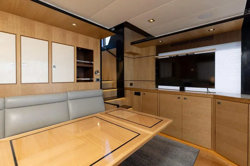 Slide: The Image of Luxurious interior of 2023 North Pacific 49 Euro yacht with modern wood finishes and TV. - 8
