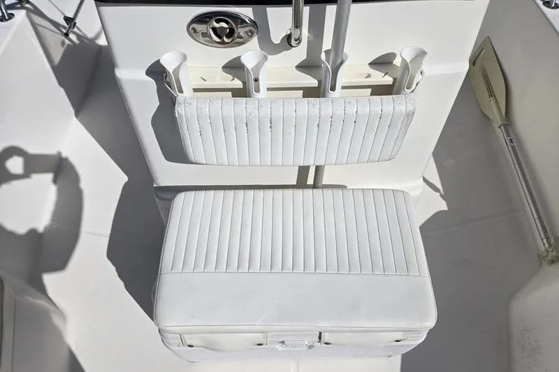Slide: The Image of 2007 Boston Whaler 190 Montauk boat seat with rod holders and white upholstery. - 13