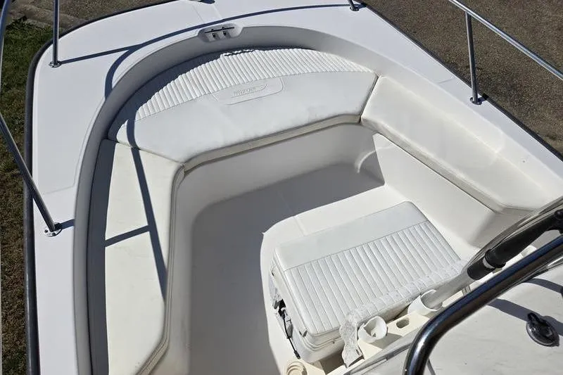 Slide: The Image of 2007 Boston Whaler 190 Montauk boat interior with cushioned seating and cooler. - 14