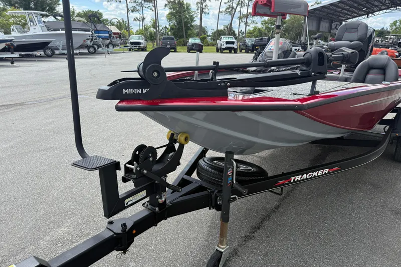 Slide: The Image of 2023 Pro Team 195 boat on trailer in outdoor lot, featuring Minn Kota trolling motor. - 10