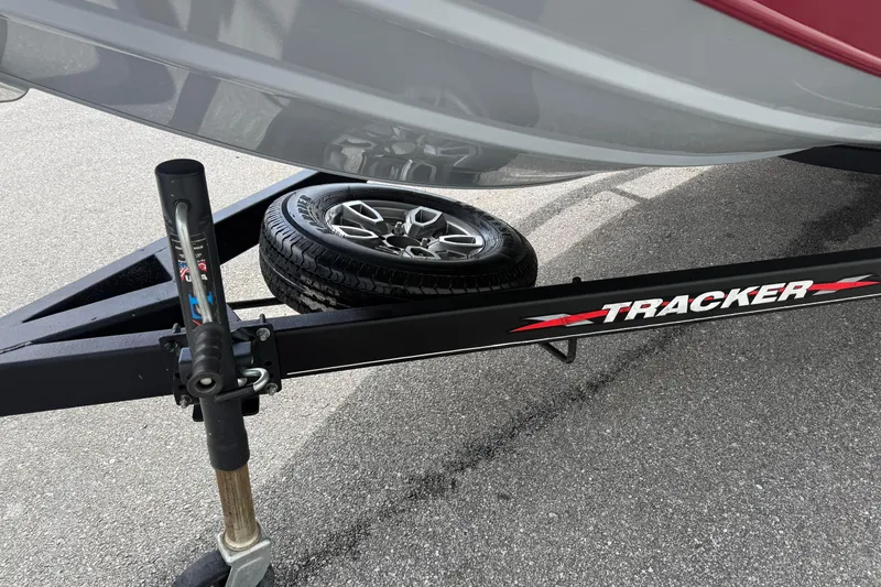 Slide: The Image of Trailer hitch and spare tire of 2023 Tracker Pro Team 195 boat on pavement. - 11