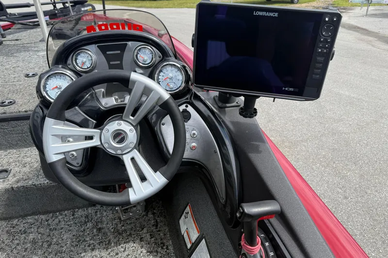 Slide: The Image of Cockpit of 2023 Pro Team 195 boat with steering wheel and Lowrance display. - 16