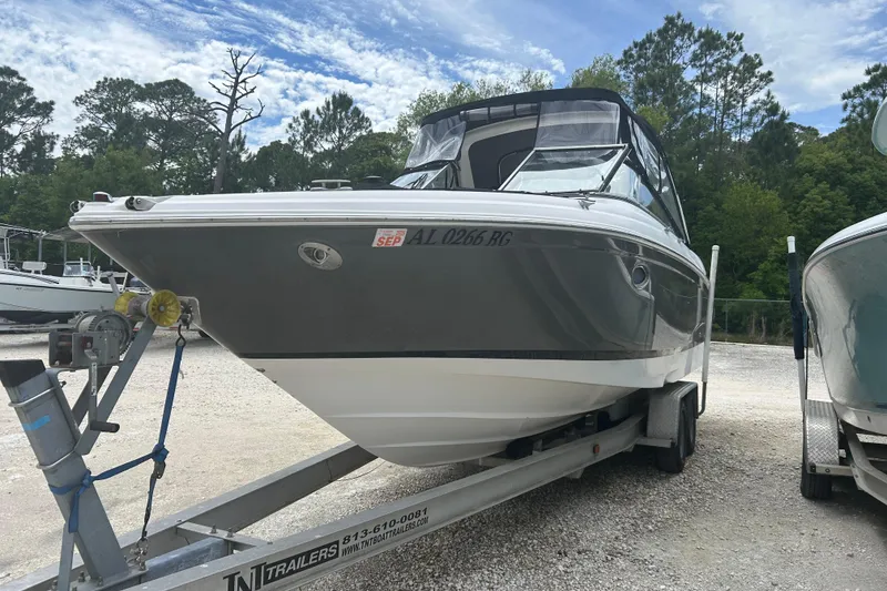 The Image of 2008 Regal 2700 Bowrider boat on trailer, parked outdoors with trees in background. - 0