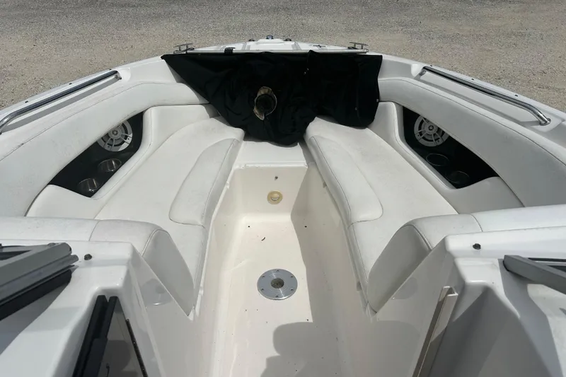 Slide: The Image of 2008 Regal 2700 Bowrider interior with white seating and cup holders. - 13