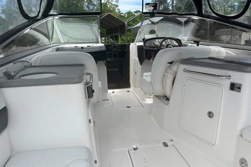 Slide: The Image of 2008 Regal 2700 Bowrider interior with white seating and dashboard view. - 15