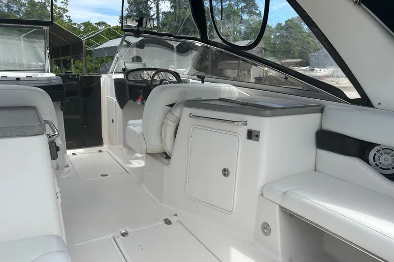 Slide: The Image of 2008 Regal 2700 Bowrider interior with white seating and modern dashboard. - 16