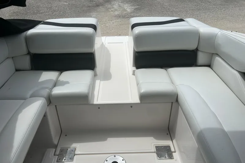 Slide: The Image of Interior seating of a 2008 Regal 2700 Bowrider boat, featuring white upholstery. - 18