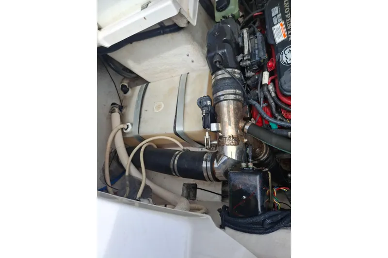 Slide: The Image of Engine compartment of a 2008 Regal 2700 Bowrider boat, showing hoses and components. - 21