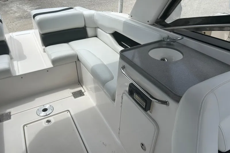 Slide: The Image of 2008 Regal 2700 Bowrider interior with seating and compact sink area. - 3