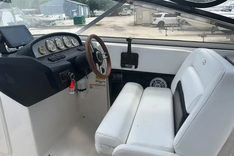 Slide: The Image of Interior of a 2008 Regal 2700 Bowrider boat with steering wheel and dashboard. - 5
