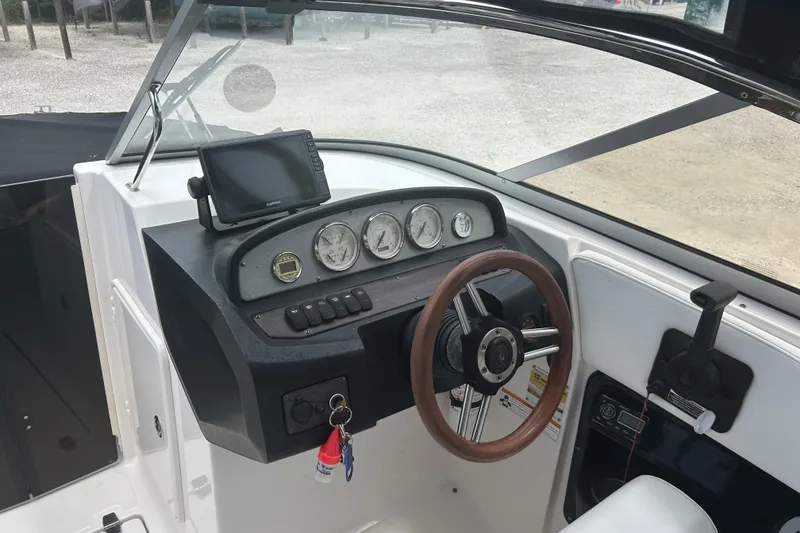 Slide: The Image of 2008 Regal 2700 Bowrider dashboard with steering wheel and navigation instruments. - 6