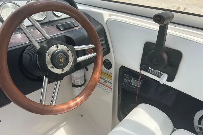 Slide: The Image of 2008 Regal 2700 Bowrider dashboard with wooden steering wheel and control panel. - 7