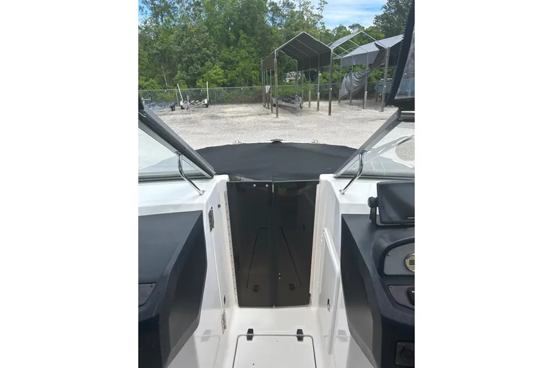 Slide: The Image of 2008 Regal 2700 Bowrider interior view with covered dashboard and outdoor setting. - 9
