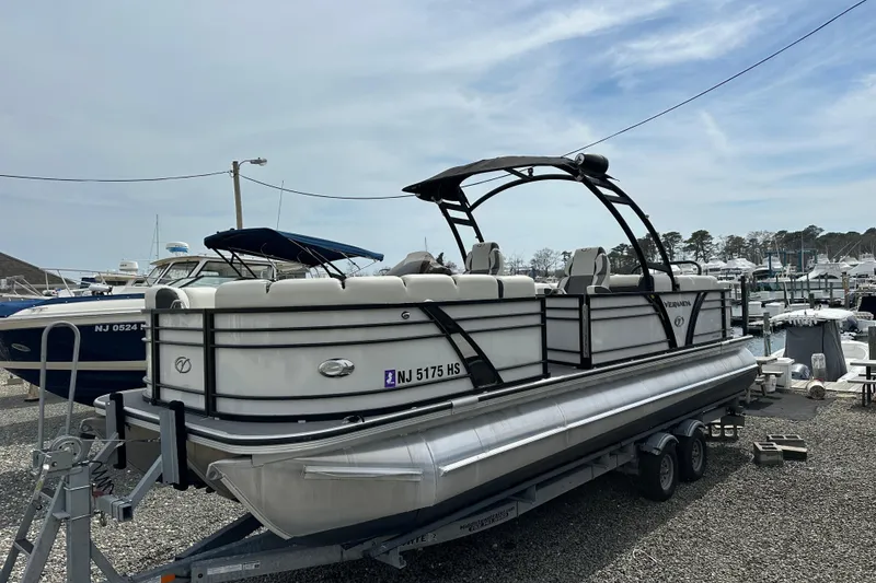The Image of 2024 Veranda VP Tower 25 RCT pontoon boat on trailer at marina. - 0