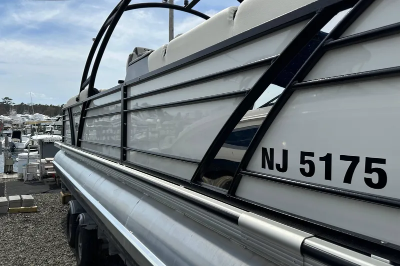 Slide: The Image of 2024 Veranda VP Tower 25 RCT pontoon boat docked, displaying registration number NJ 5175. - 18