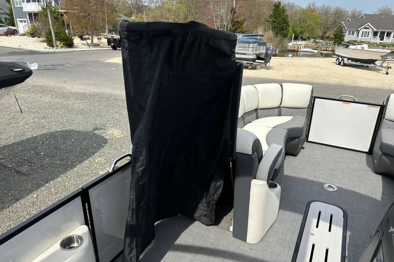 Slide: The Image of 2024 Veranda VP Tower 25 RCT pontoon boat interior with seating and privacy curtain. - 32