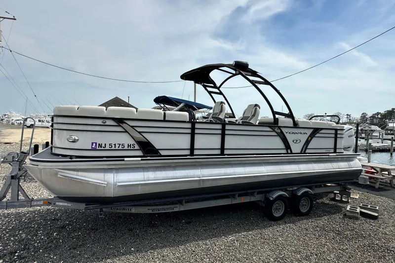Slide: The Image of 2024 Veranda VP Tower 25 RCT pontoon boat on trailer at marina. - 35