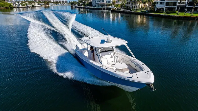 Slide: The Image of 2019 Everglades 355 Center Console cruising on calm water. - 10