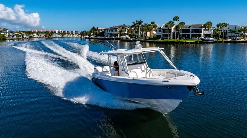 Slide: The Image of 2019 Everglades 355 Center Console cruising on calm waters. - 11