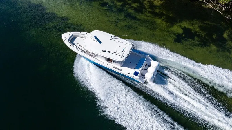Slide: The Image of Aerial view of 2019 Everglades 355 Center Console boat on water. - 12