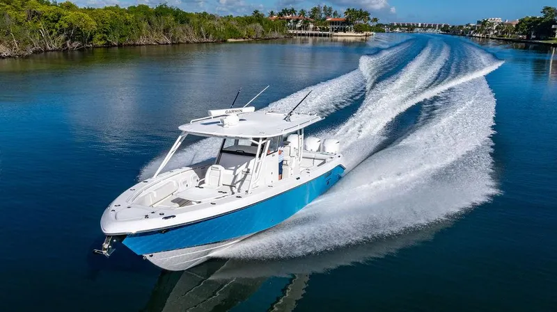 Slide: The Image of 2019 Everglades 355 Center Console cruising on calm waters. - 2