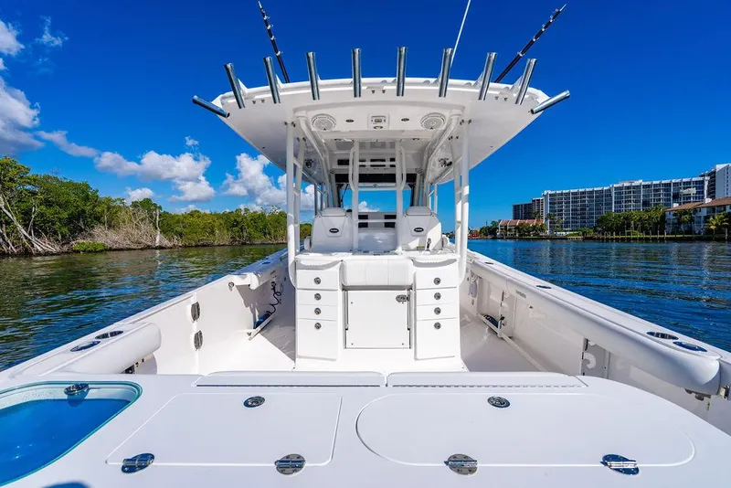 Slide: The Image of 2019 Everglades 355 Center Console on calm water near buildings. - 35