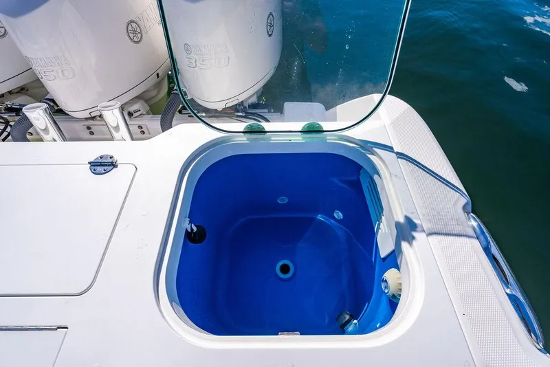 Slide: The Image of 2019 Everglades 355 Center Console with open blue fish tank. - 38