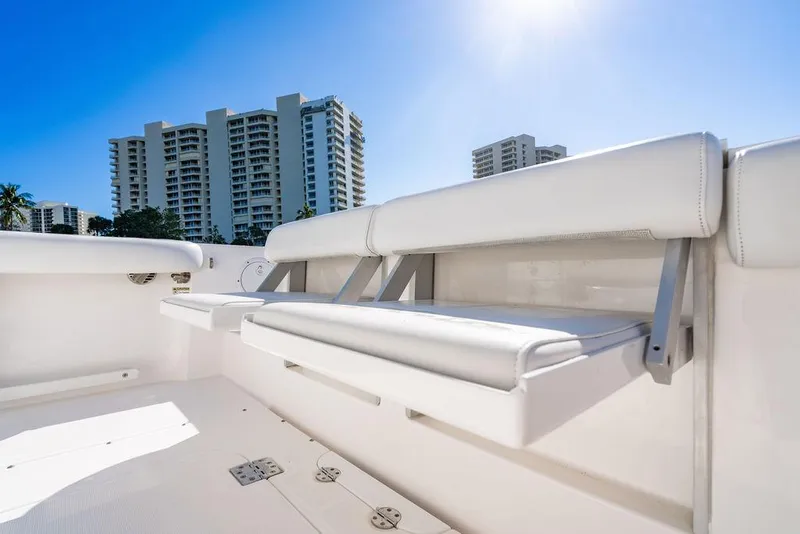 Slide: The Image of Everglades 355 Center Console 2019 with white seating and high-rise buildings in background. - 39