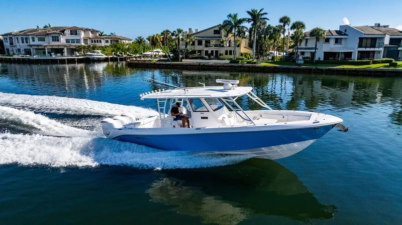 Slide: The Image of 2019 Everglades 355 Center Console boat on water near villas. - 8